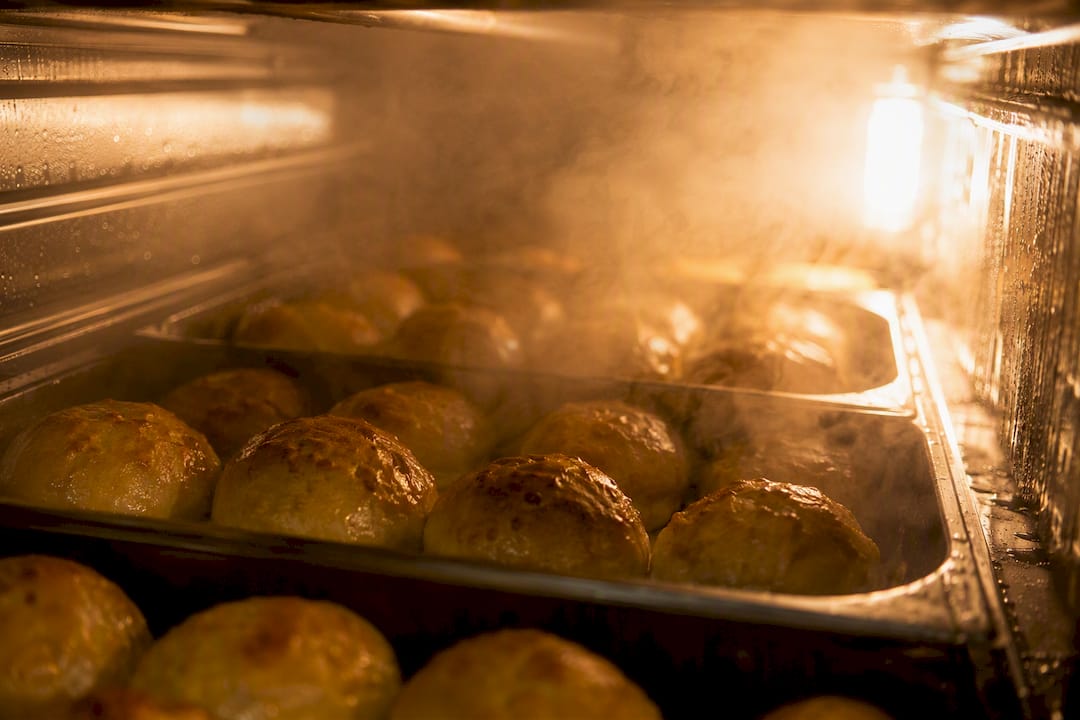 Steam inside commercial oven cooking bread