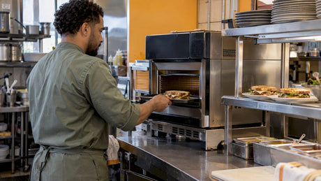 Cook loading sandwich into commercial speed oven